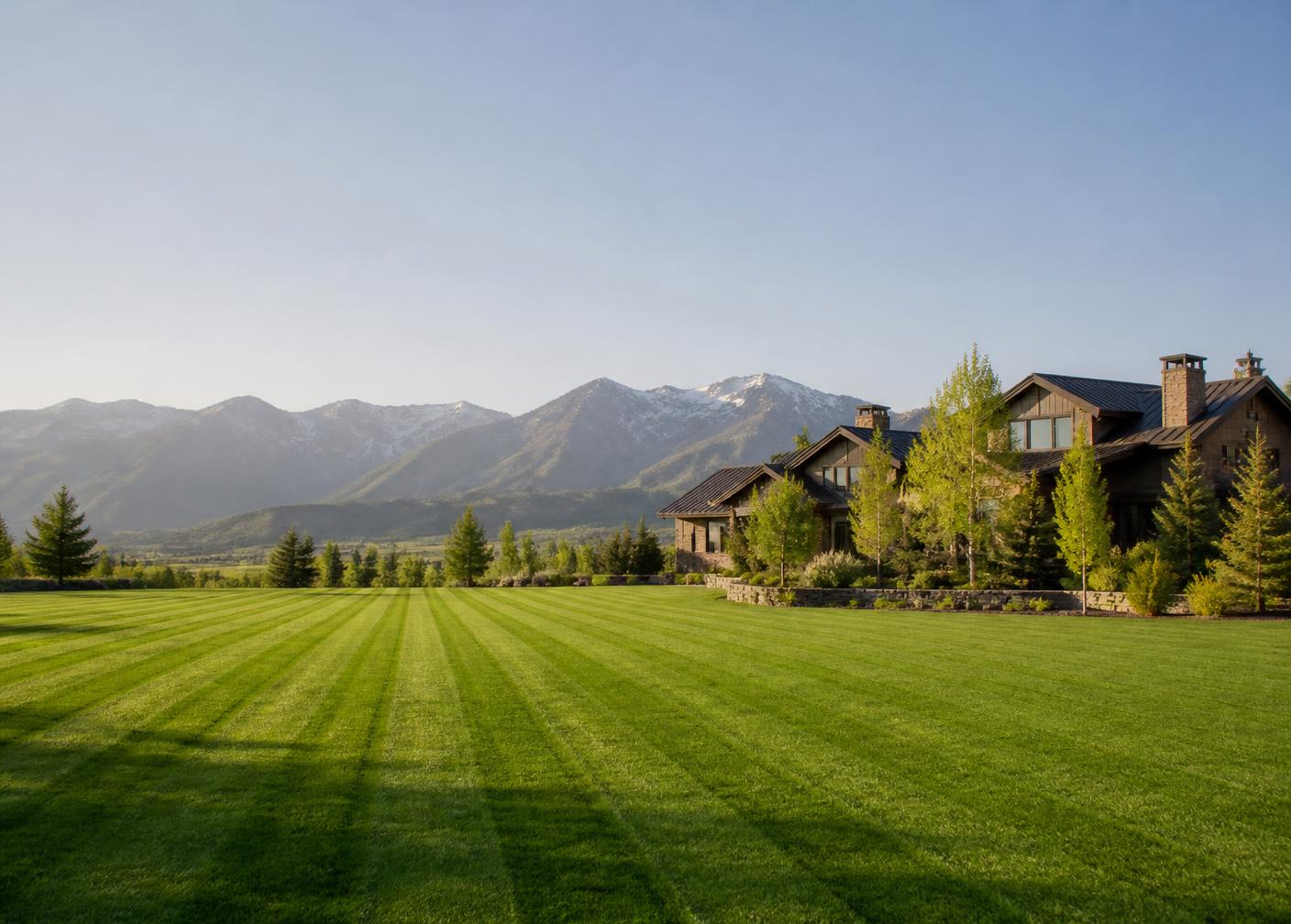 Striped, freshly mowed lawn with a Sierra Nevada backdrop